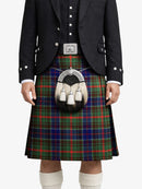 Person wearing a traditional Scottish kilt with a sporran on a white background
