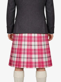 Person wearing a gray jacket and pink plaid kilt on a white background