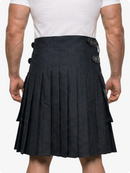 Person wearing a black pleated kilt with button details on a white background