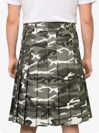 Camouflage pleated skirt worn by a person on a plain background