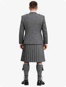 Person wearing a gray Highland kilt with a jacket on a white background