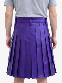 Person wearing a purple pleated skirt with a gray shirt on a white background