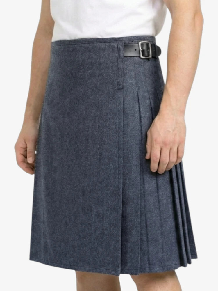 Person wearing a blue pleated skirt with a belt on a white background