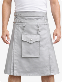 Person wearing a gray leather skirt with multiple pockets and metal accents on a white background