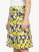 Skirt with yellow and gray pattern worn by a person on a white background