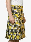 Yellow and gray camouflage skirt worn by a person on a white background