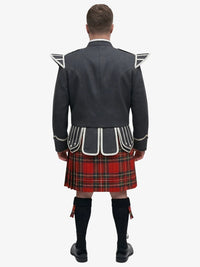 Person wearing a traditional Scottish royal stewart tartan kilt with a dark jacket on a white background