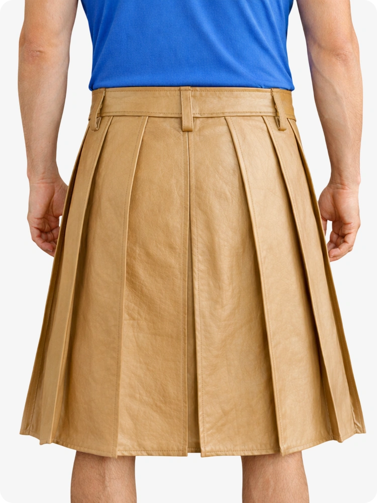 Person wearing a tan pleated skirt and blue top on a white background