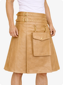 Tan leather skirt with gold buckles and pockets on a white background