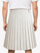 Beige pleated skirt worn by a person on a white background