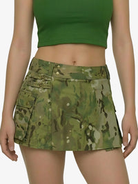 Person wearing a green camouflage skirt and green top on a white background