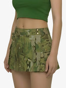 Person wearing a green camouflage skirt on a white background