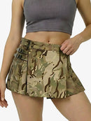 Camouflage skirt worn by a person on a white background